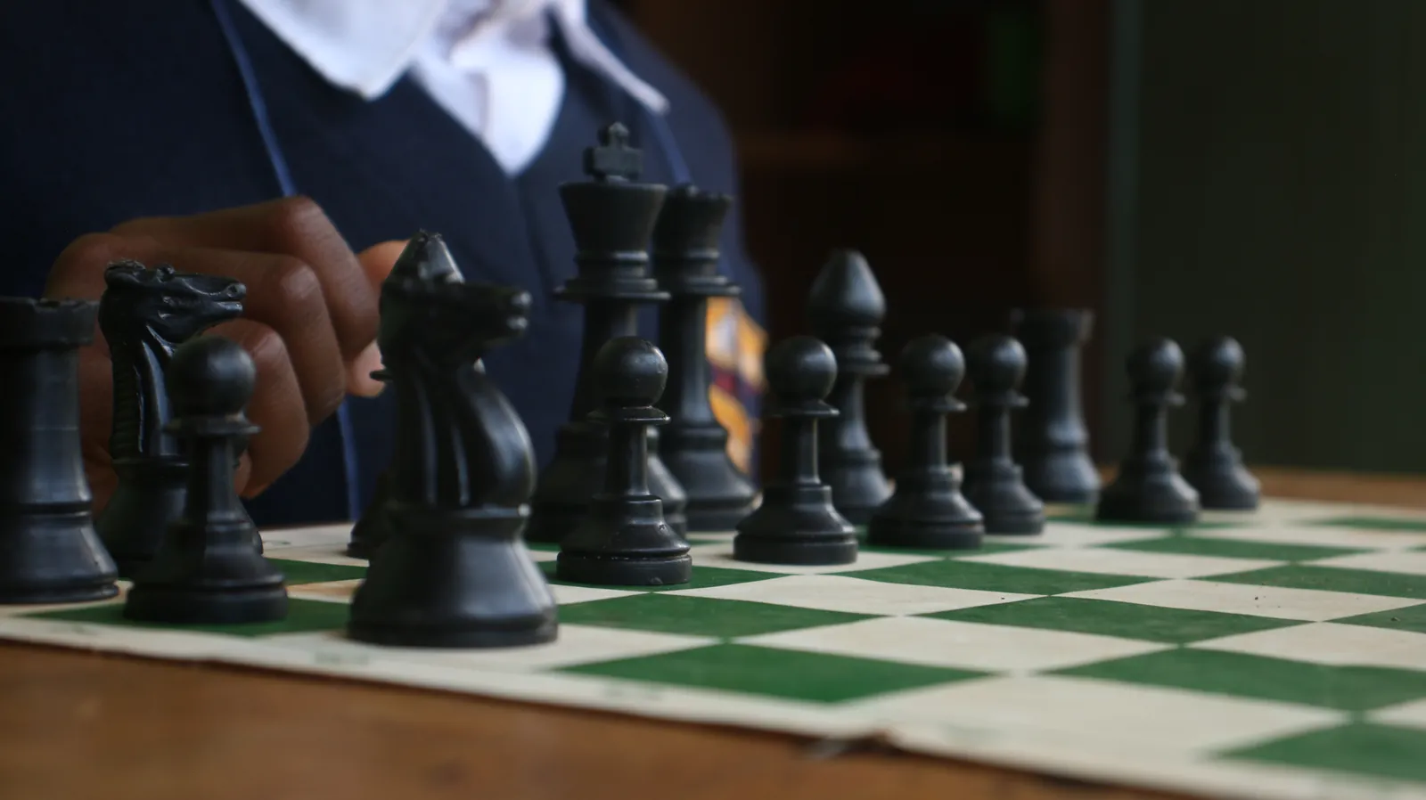 Chess club member studying the board at Sikri Sports Academy